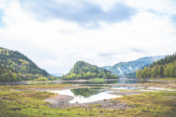 A hill surrounded by a lake