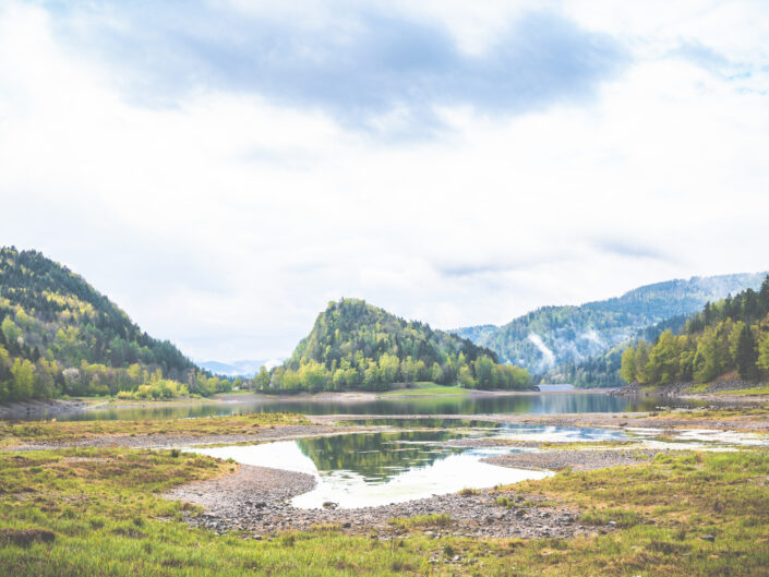 A hill surrounded by a lake